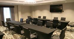 Meeting Room with Two Conference Tables, Chairs and Wall Mounted Television
