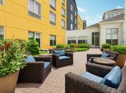 Spacious outdoor patio featuring comfortable seating and lush landscaping.