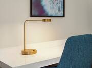 Stunning guest room details featuring beautiful artwork and brass desk lamp.