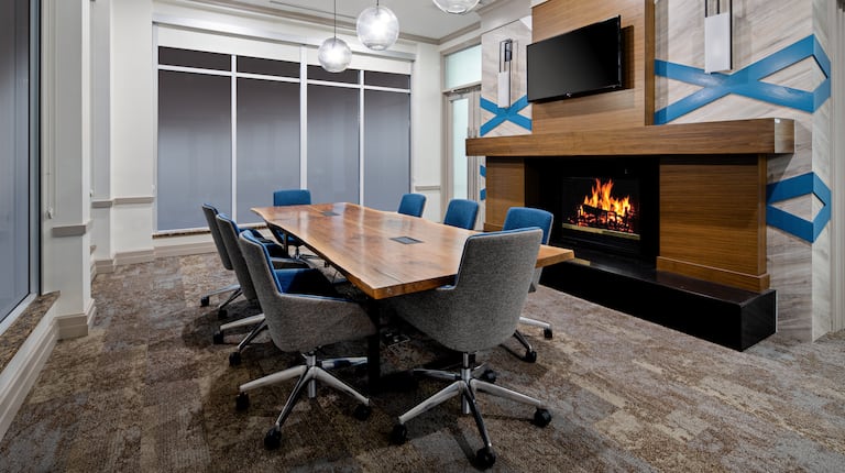 Board room with tables chairs and a fireplace