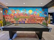 lobby with mural and pool table