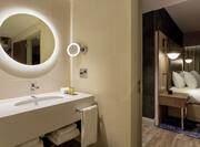 Presidential Suite Bathroom Vanity Area with a Round Lit Mirror