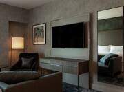 Suite with HDTV and Sofa and Reflection of Bed in Mirror