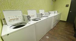 Guest Laundry Room with Coin-Operated Dryers and Washing Machines