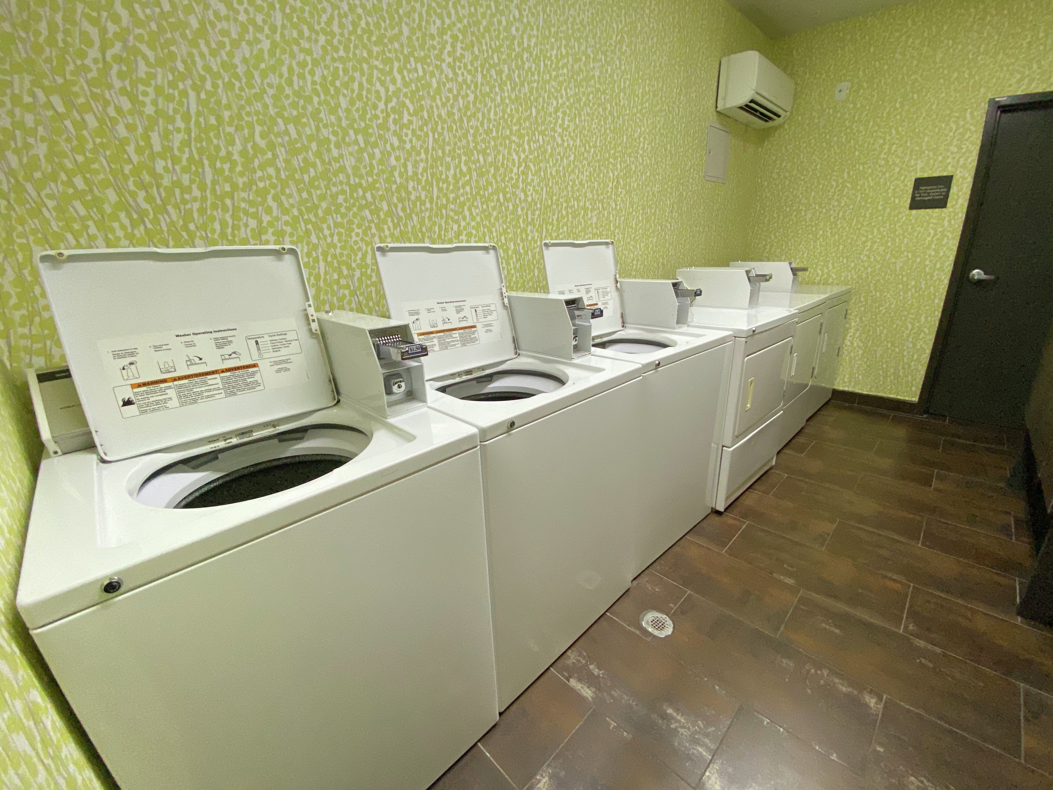 Guest Laundry Room with Coin-Operated Dryers and Washing Machines