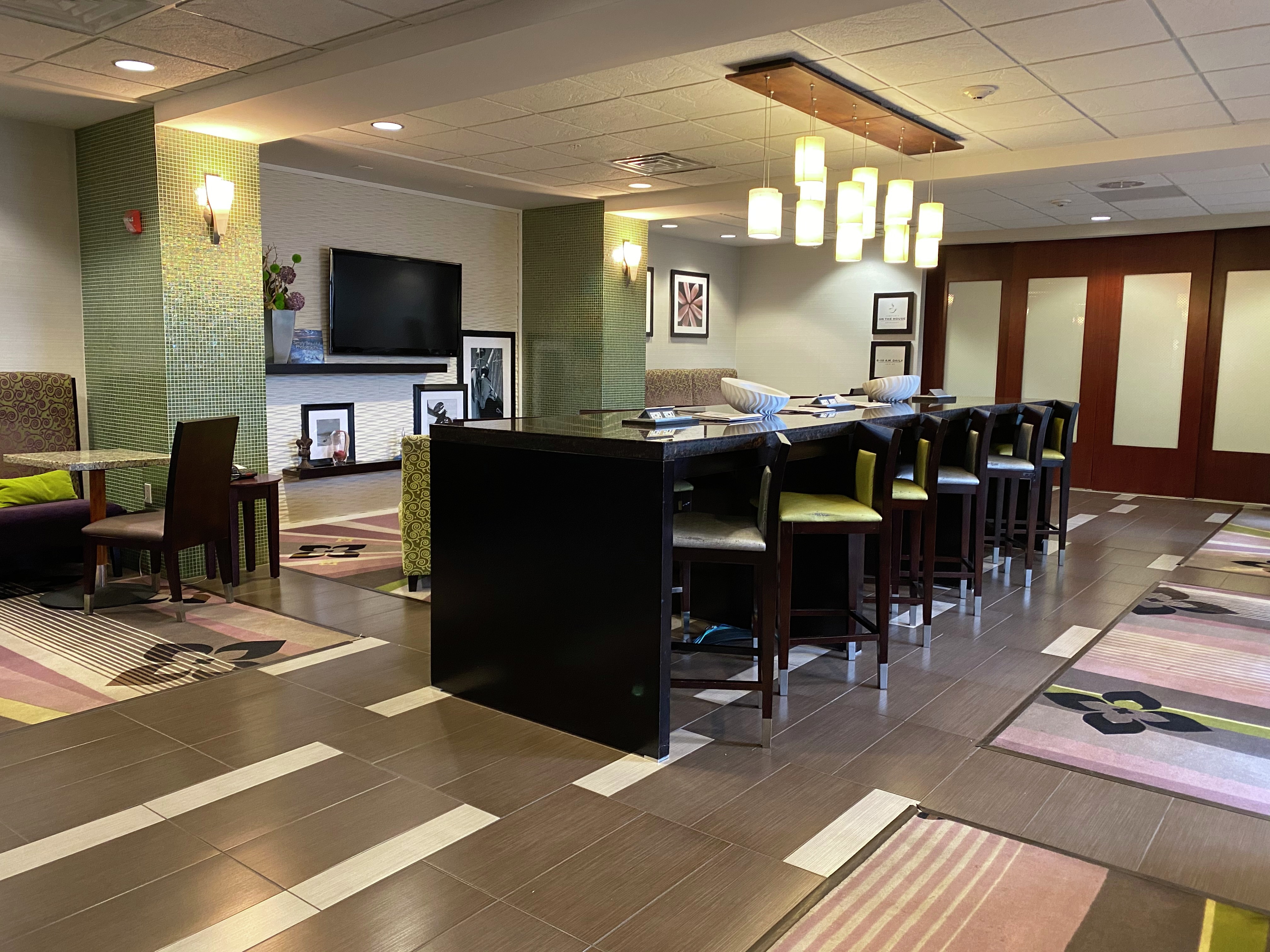 Lobby Bar Area with Stools, Tall Table and Wall Mounted TV