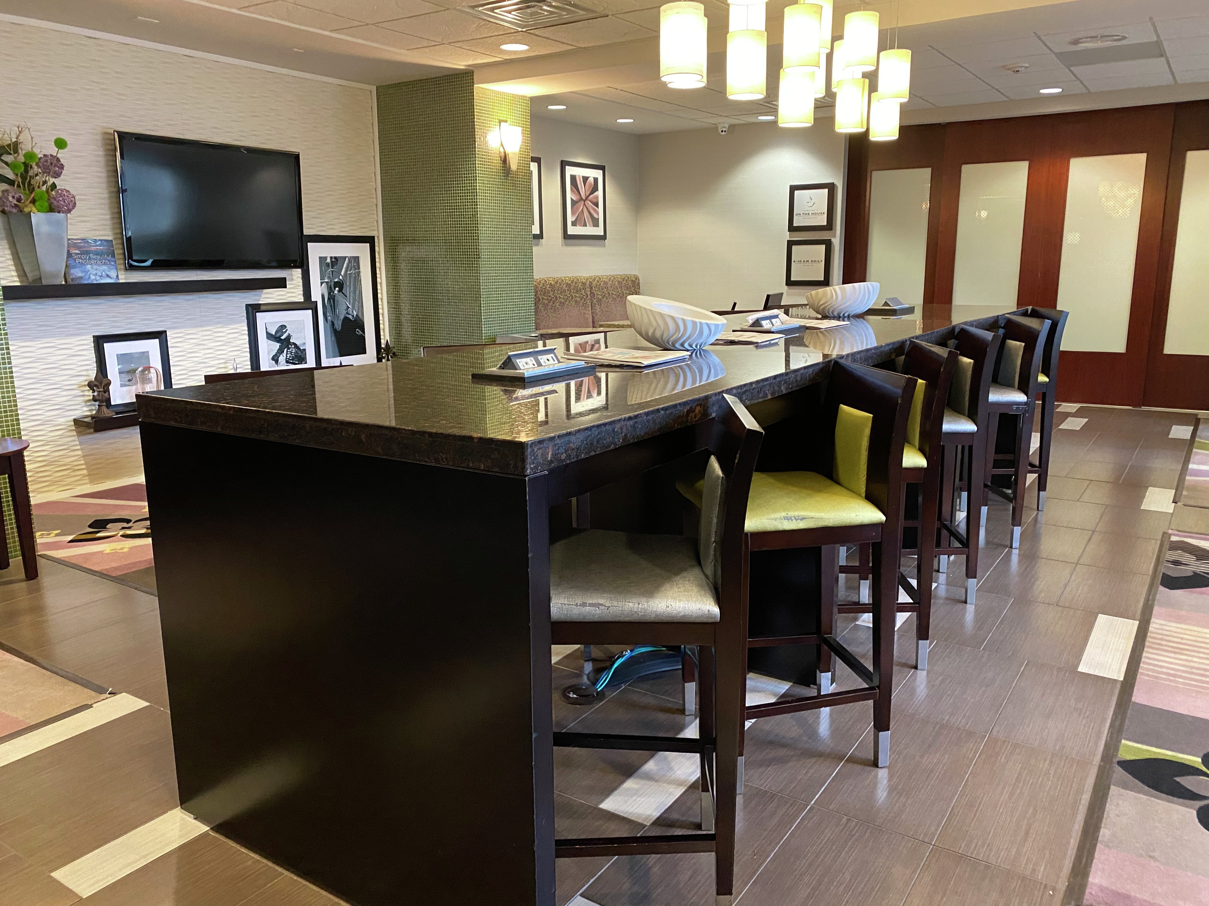 Lobby Bar Area with Stools, Tall Table and Wall Mounted TV
