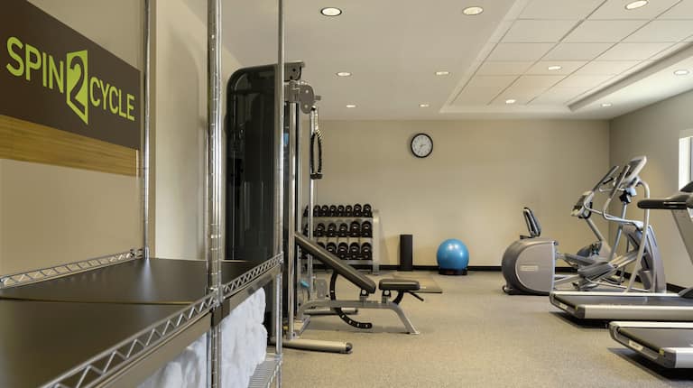Fitness Center with Workout Equipment and Fresh Towels 