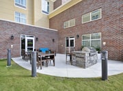 Outdoor Patio Seating Area with Chairs, Tables and BBQ Grill