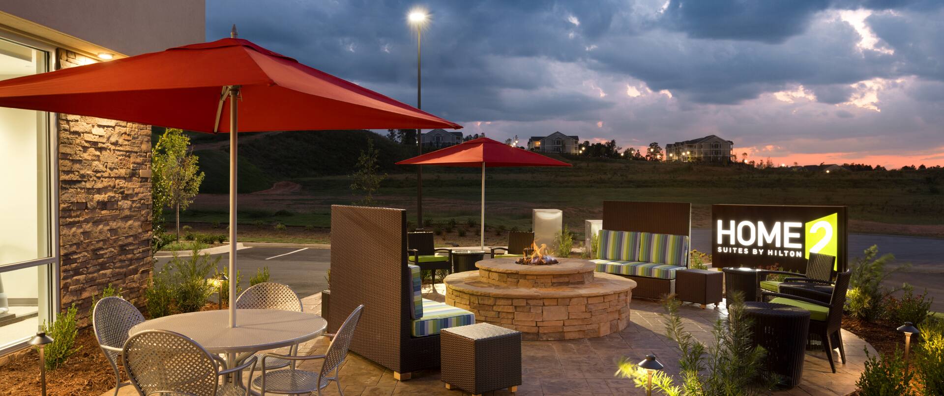 Outdoor Lounge with Fire Pit Table at Dusk