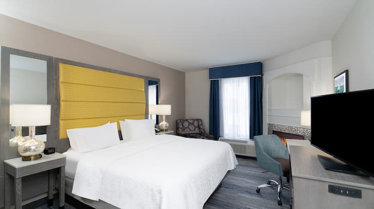 Large Bed Desk and HDTV in Hotel Guest Room