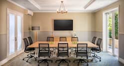 Boardroom Meeting Table with Office Chairs and Wall Mounted HDTV