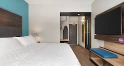 Single king bed guest room with entrance in background