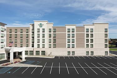 Daytime View of Hotel Exterior and Parking Lot