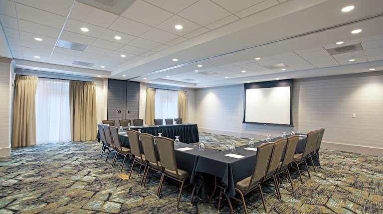 Meeting Room in U Shape Set up with a Projection Screen