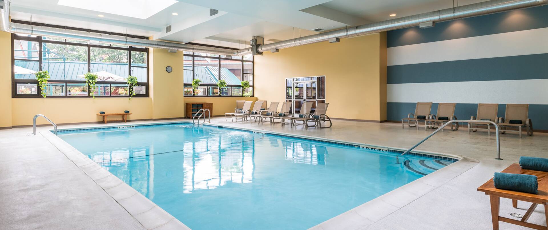 Indoor pool with loungers and handrail