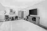 King bedroom with table and seating and TV