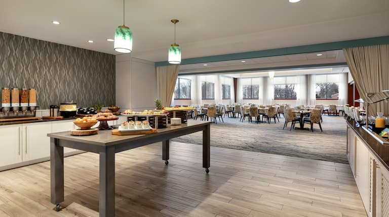 Bright breakfast area featuring complimentary daily buffet overflowing with delicious food.