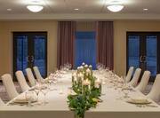 Spacious indoor event space featuring beautiful table setting..