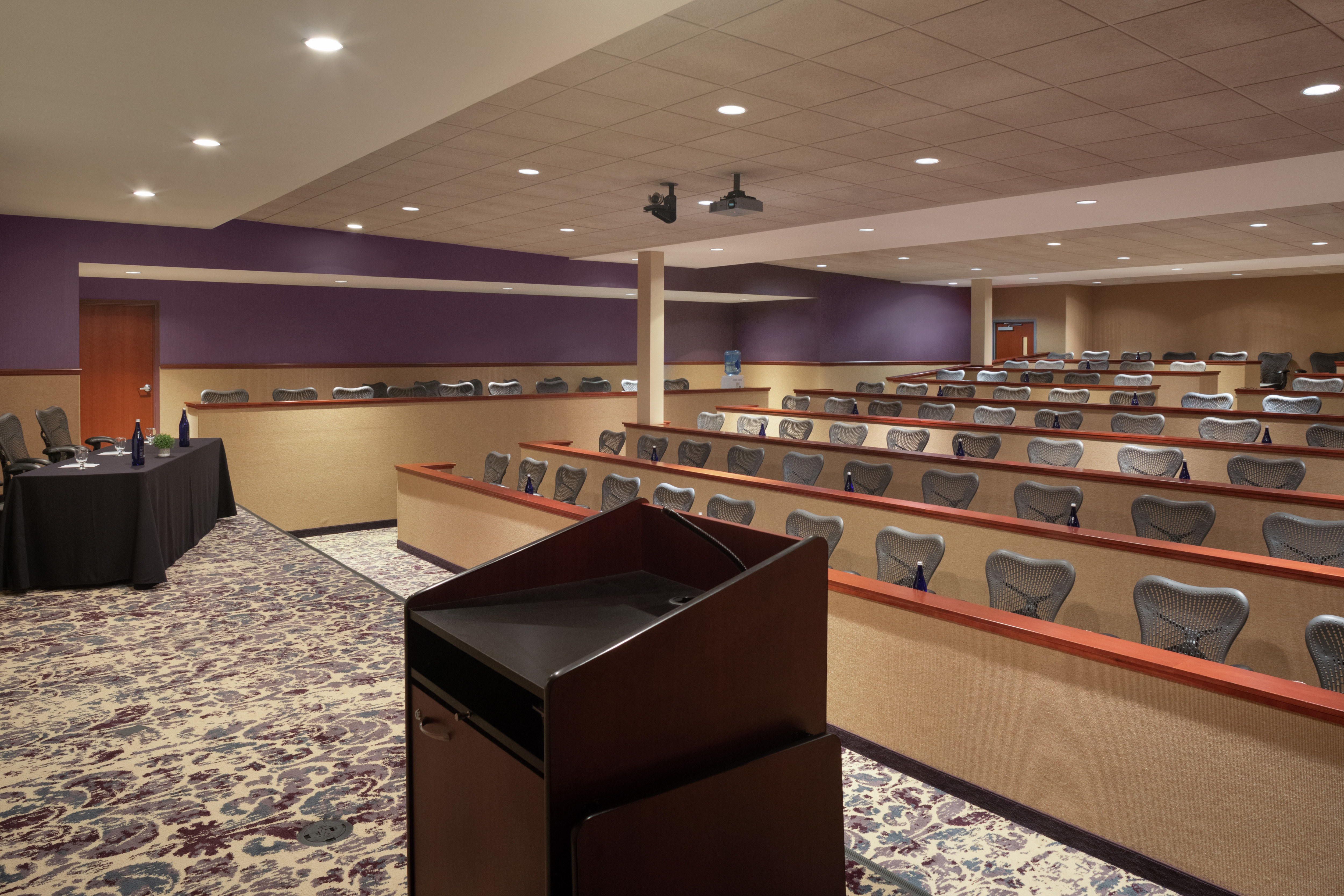 Spacious on-site amphitheater featuring ample classroom style seating, stage, and podium.