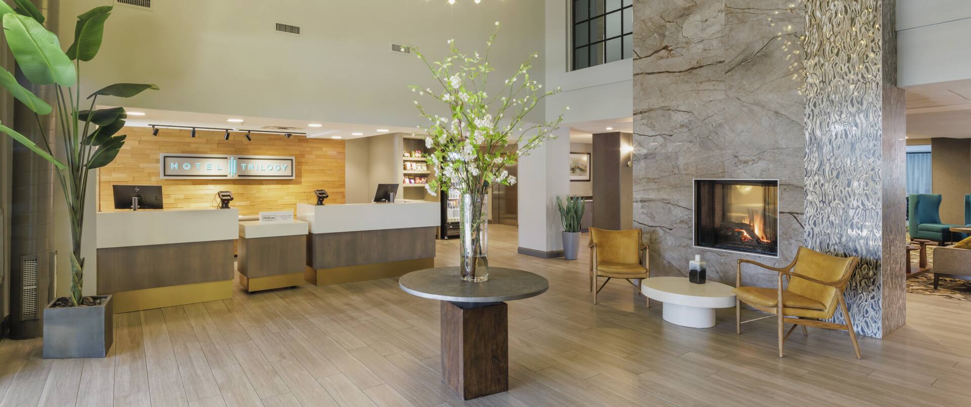 Lobby area with front desk, tables and chairs