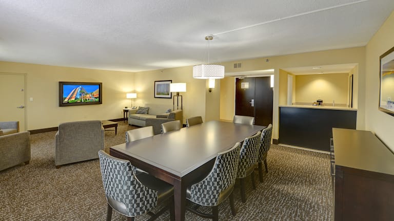 Guest Suite Lounge Area with Chairs, Table and Wall Mounted HDTV