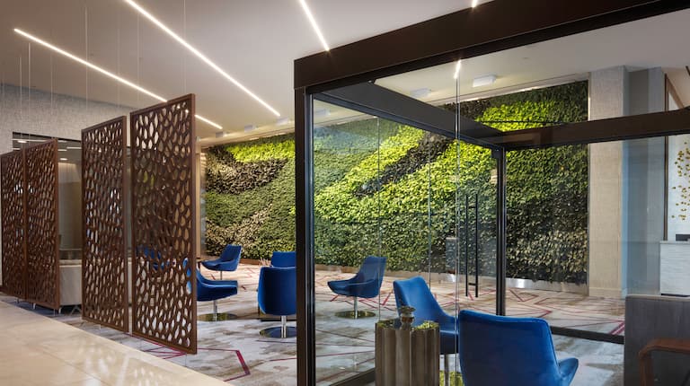 Lobby Seating Area with Armchairs and Plant Life Wall