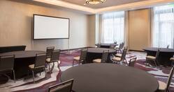 Meeting Room with Round Tables, Chairs and Projector Screen