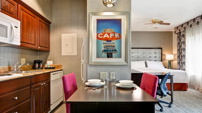 Suite Kitchenette with Dining Area and Bed