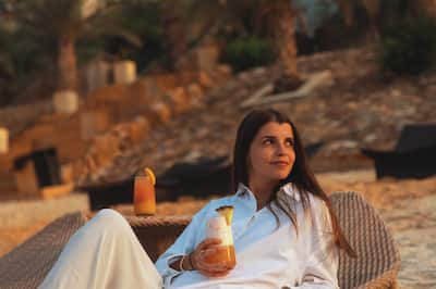 Woman Enjoying Drinks at the Beach