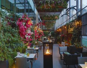Nasma Beirut restaurant, with tables and chairs surrounded by plants
