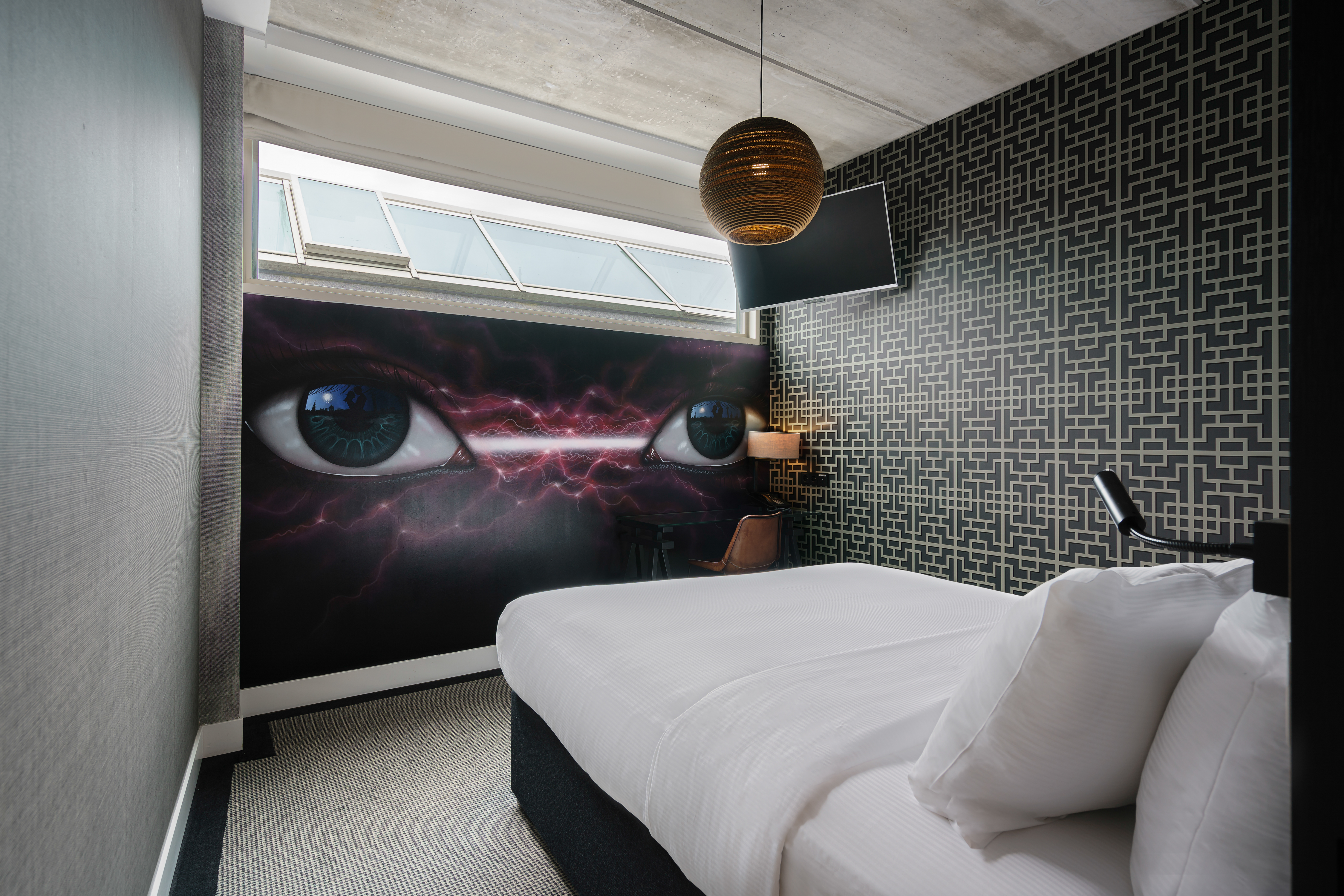 Eyes Mural in a Guest Room with a Queen Bed and HDTV