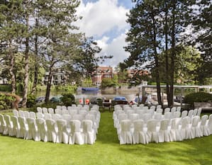 chair covers and chairs in grass area looking onto river