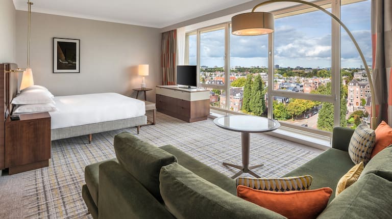 Suite with a Large Bed Sofa and Large Windows with City View