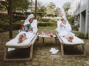 women in spa robes on lounge chairs