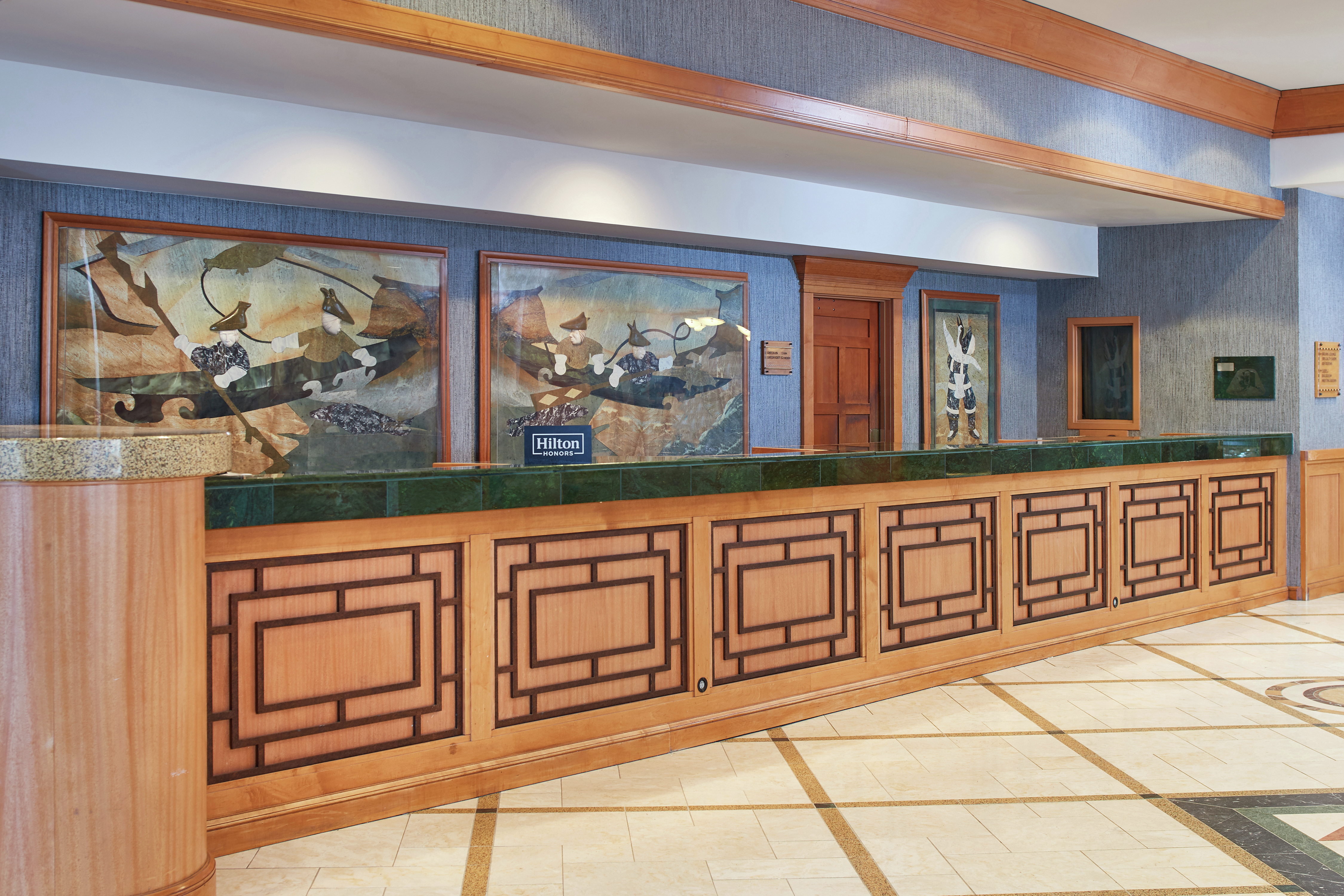 Reception desk with Alaskan art on display on the wall