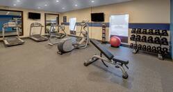 Fitness Center with HDTVs Weights  Treadmills and Recumbent Bike