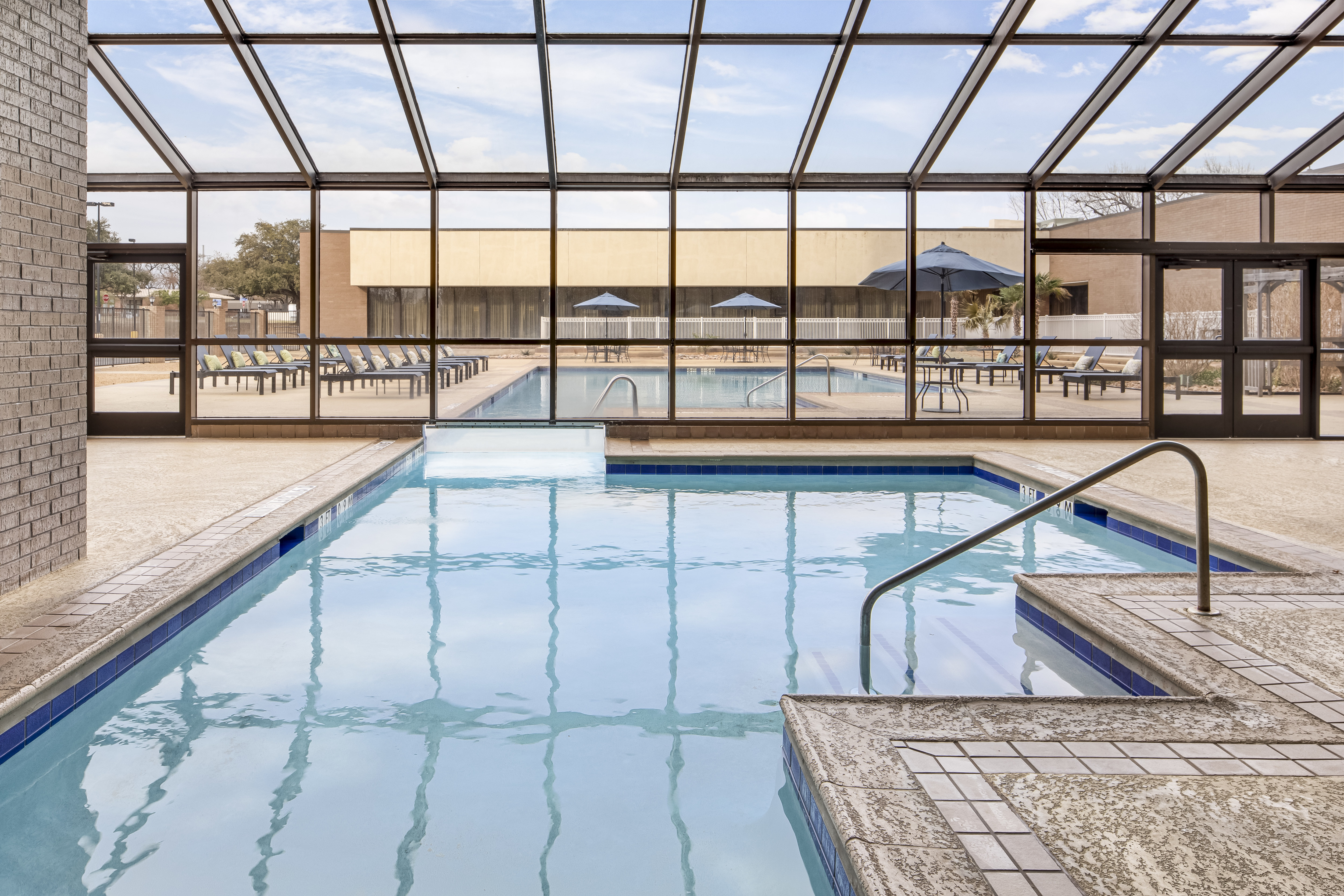 Outdoor and Indoor Pool Areas with Large Windows
