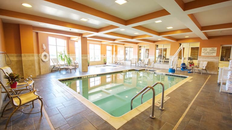 Indoor heated pool with whirlpool and deck seating