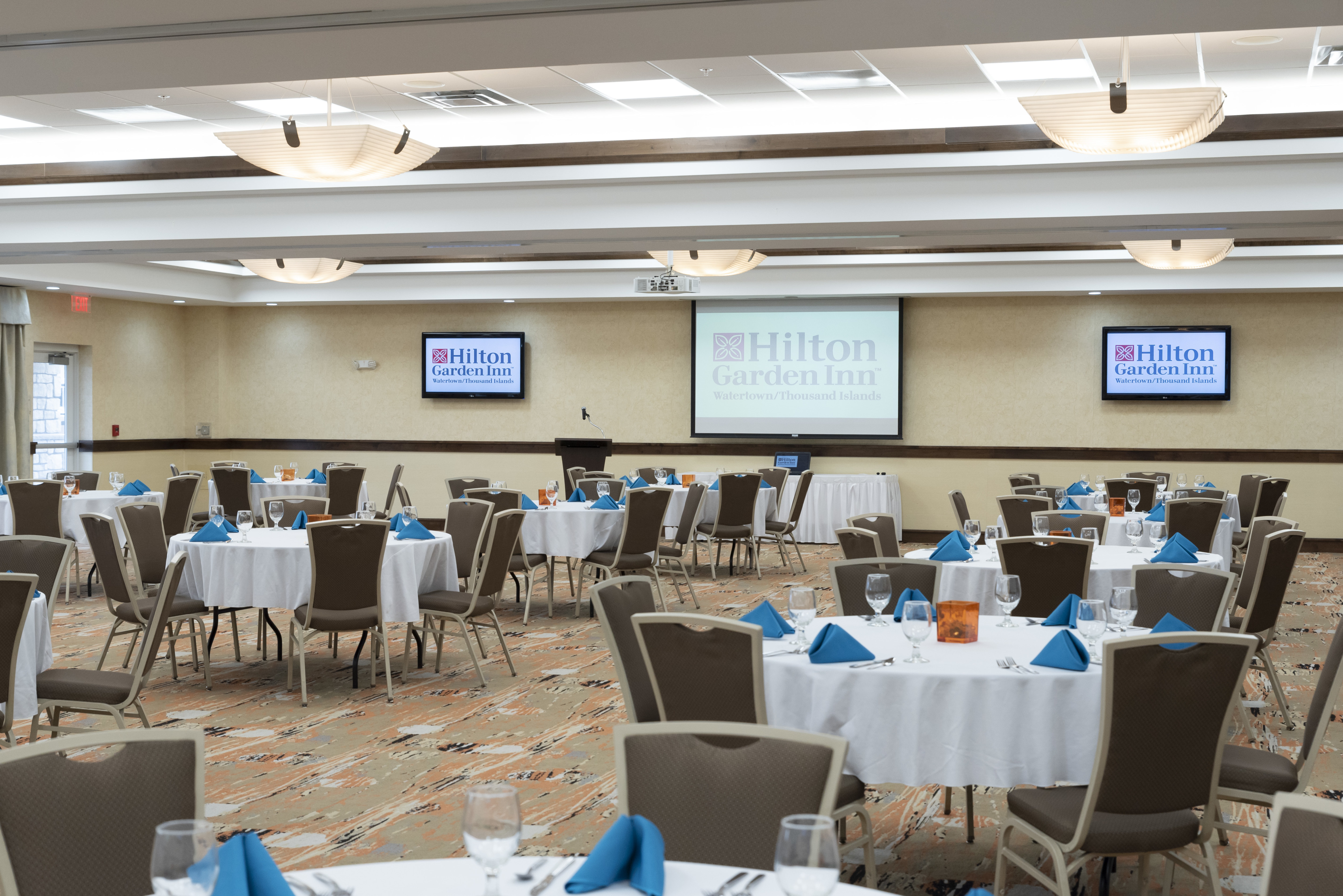 Round Tables in City Center Ballroom with HDTVs and a Projection Screen