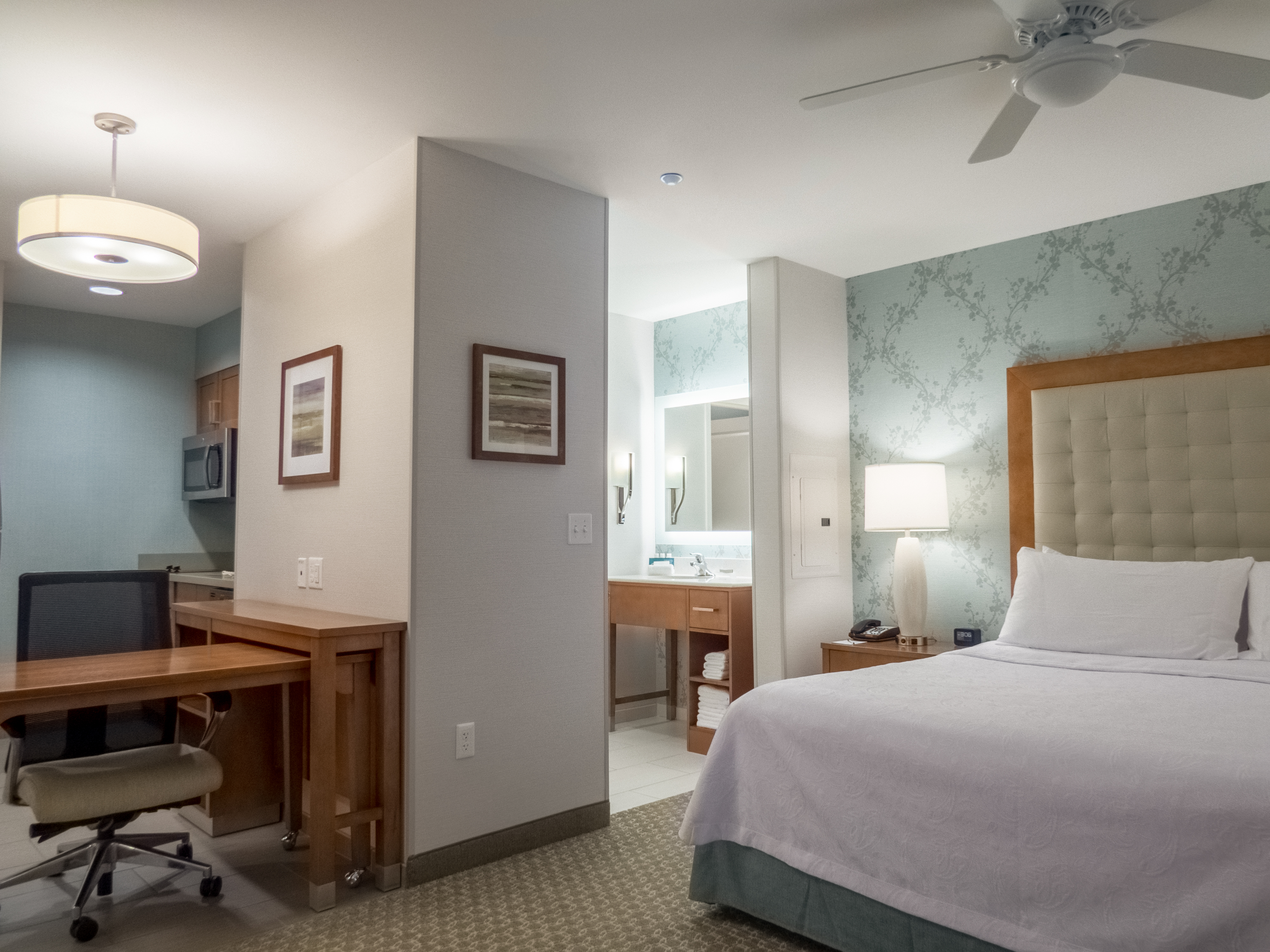 Hearing Accessible Guestroom with King Bed, Work Desk and Entry to Bathroom