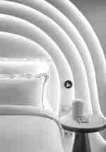 Bed in room with notepads on table