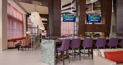 Our Modern Bar Featuring Purple Bar Stools, Two HDTVs and Private Seating Areas