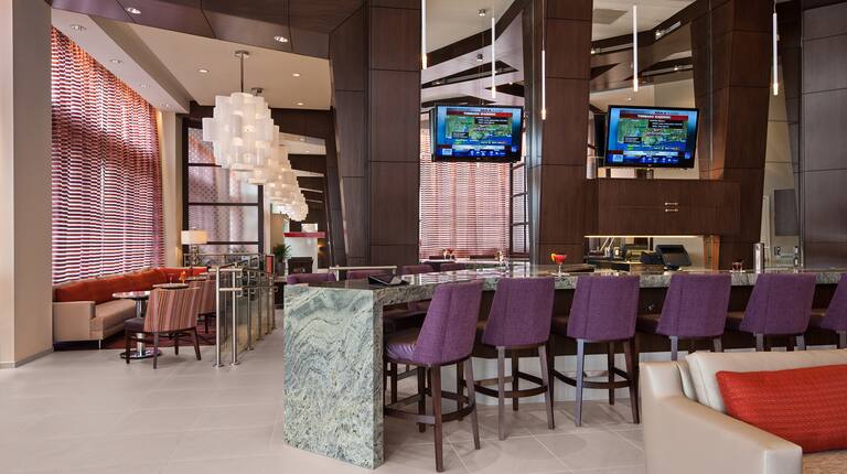 Our Modern Bar Featuring Purple Bar Stools, Two HDTVs and Private Seating Areas