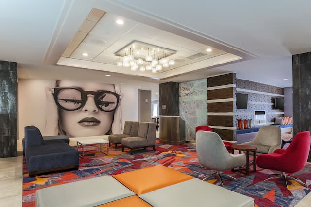 Overview of Lobby Lounge Area With Wall Mural and Colorful Seating Options