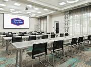 Classroom Setup in Holms Ballroom With Overhead Projector, Tables and Chairs Facing Presentation Screen