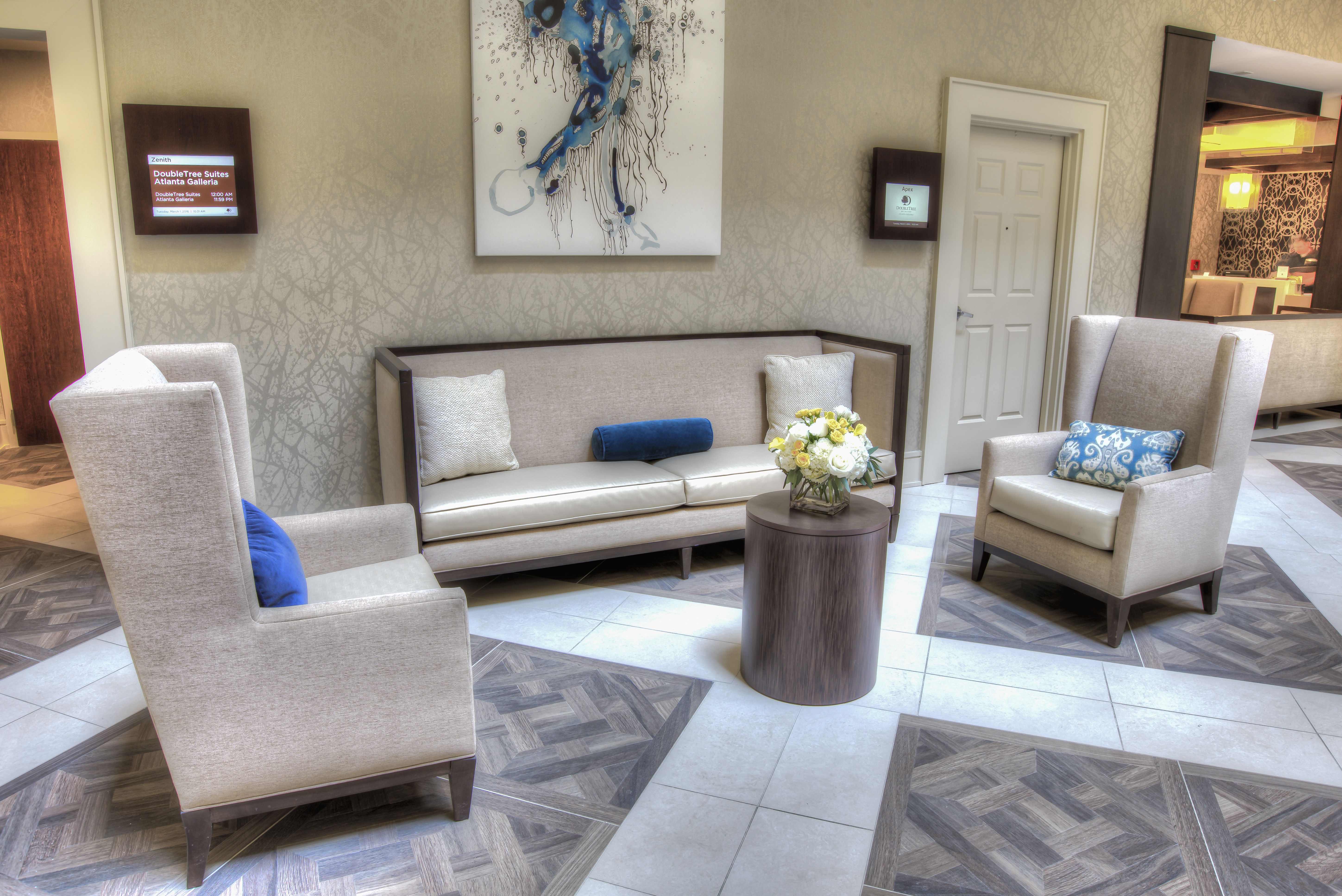 Wall Art, Table, and Lounge Seating in Lobby Area