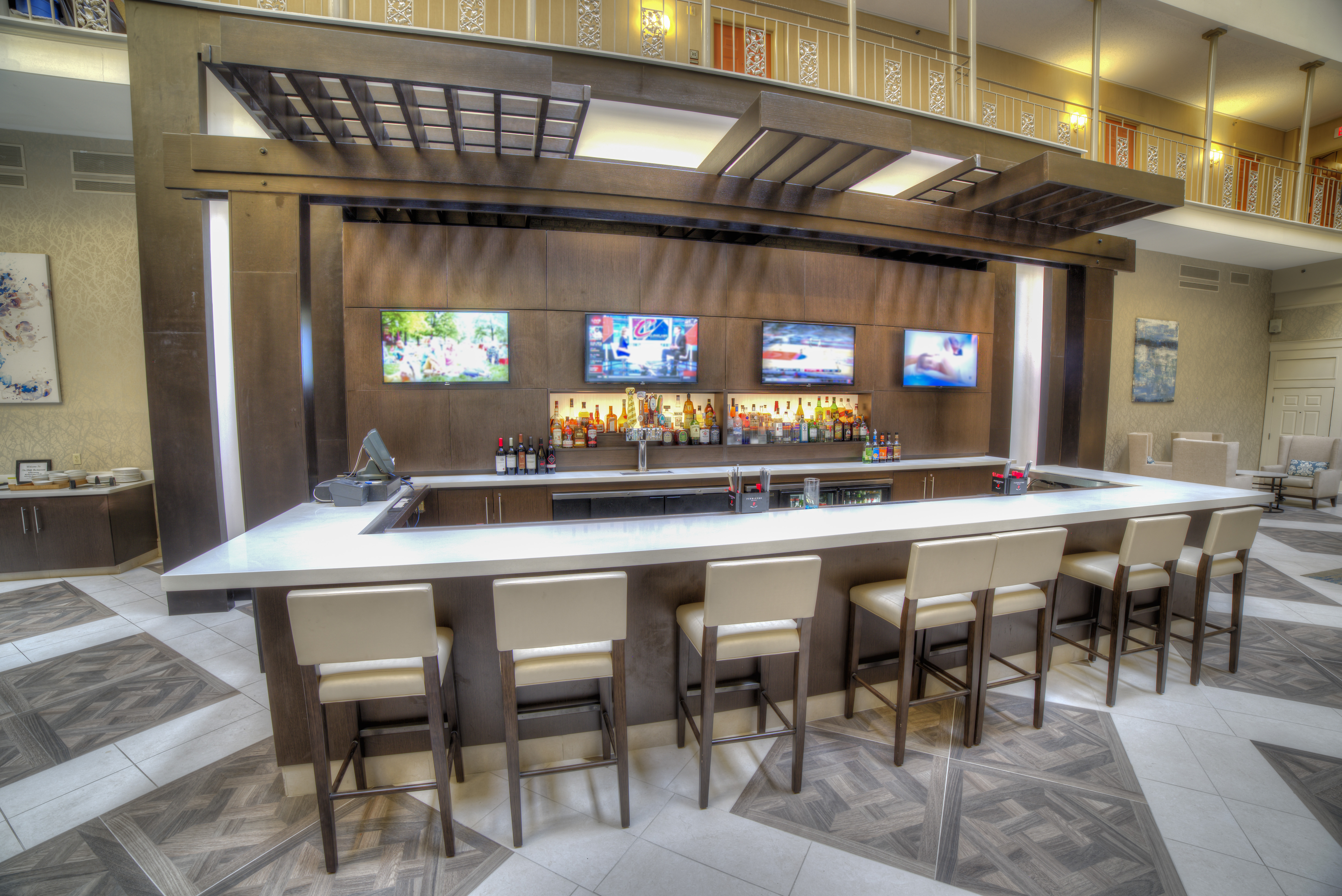 Fully Stocked Lobby Bar With Four TVs and Counter Seating