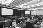 Large meeting room with dual screens and ample seating