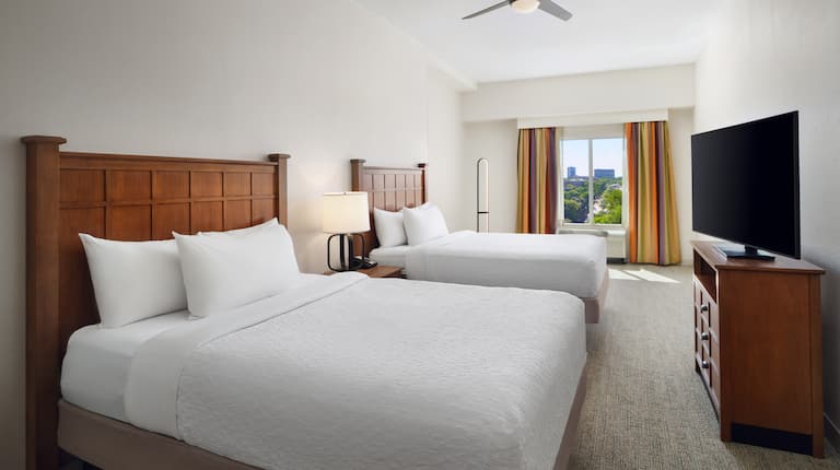 two queen beds with tv